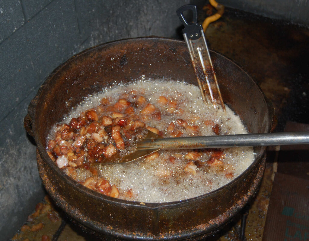 Cracklins in boiling pig fat.