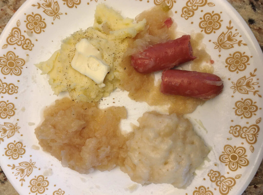 Mashed potatoes, sauerkraut, dumplings, and hot dogs