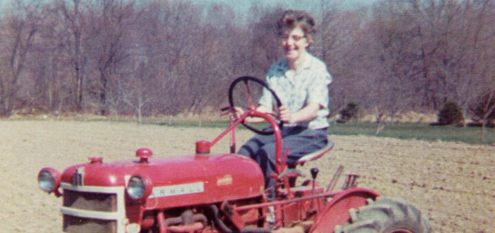 Ella Jane Hagenbuch on a Farmall tractor, 1976 Detail